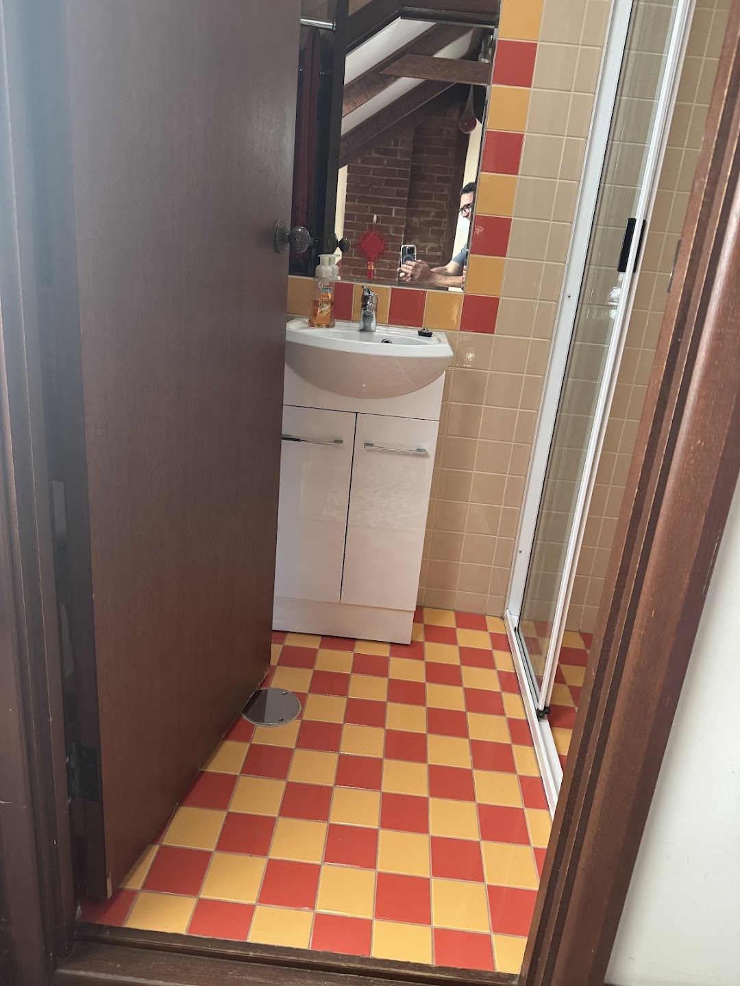 Compact character bathroom with red and yellow tiled floor